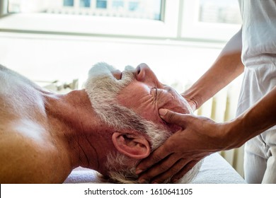 No more aches and pains. Physiotherapist working massages on client. - Powered by Shutterstock