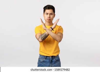 No More Drinking. Not At My Watch. Serious-looking Displeased Young Man Dont Support Something, Asking Quit Smoking, Cross Arms Making Stop Gesture, Frowning Disappointed, White Background