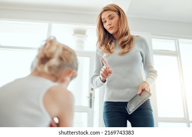 No More Screen Time For You. Shot Of A Mother Fed Up With Her Daughters Bickering About A Digital Tablet At Home.