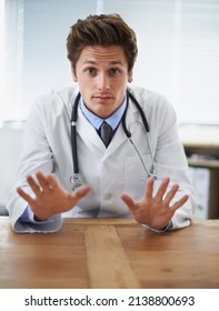 No Need To Worry At This Point.... Shot Of A Young Doctor Gesturing Not To Worry To The Camera.