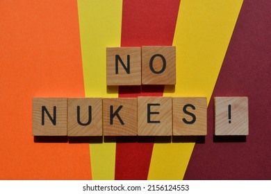 No Nukes, words in wooden alphabet letters isolated on colourful background