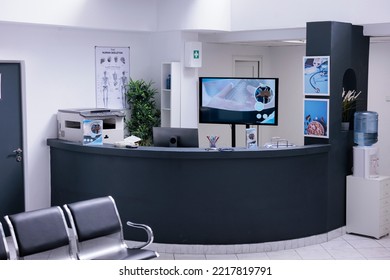 No one attending sick people in patient reception area of empty hospital. No general practitioner in check up area of empty clinic. Reception desk with nobody at sanatorium with no patients.