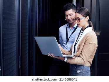No one knows networking like they do. Shot of two technicians working together in a server room.