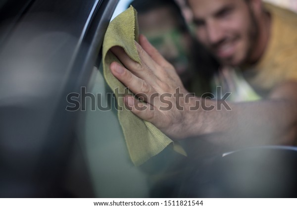  No one\
will find you a flaw. Man cleaning\
car.