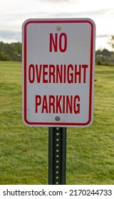 No Overnight Camping Sign With A Mowed Lawn And Hazy Sky In The Background.