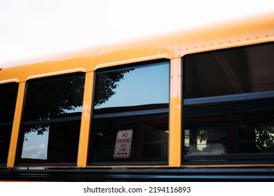 No Parking Anytime Sign In Reflection Of School Bus Window