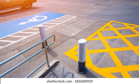 No Parking With Disabled Wheelchair Sign And Railing On Concrete Ground Surface In Parking Lot Of Public Restroom Area At Petrol Station