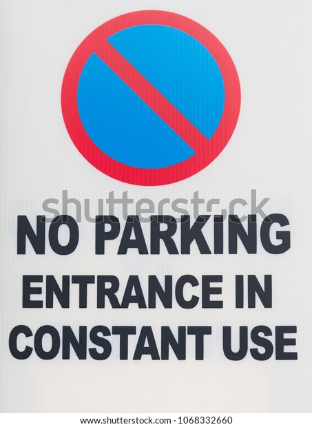 No Parking Entrance\
in constant use sign with red circle with blue fill symbol on a\
white background. 