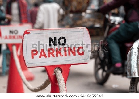 No parking red sign. A traffic sign, No Parking sign beside road in Dhaka city. bike and rickshaws passing by the sign.