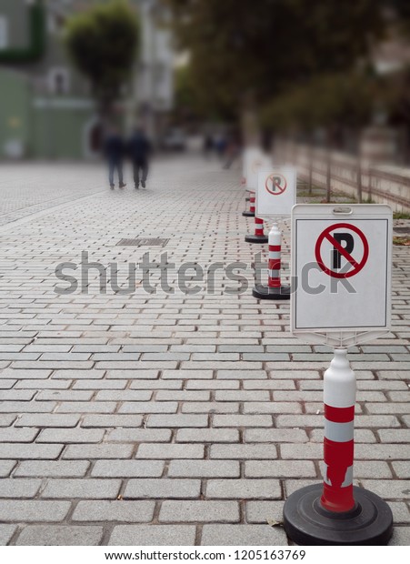 no parking sign cones at\
the pavement. cars strictly prohibited in pedestrian area. vertical\
shot