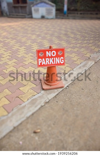 No Parking\
sign in front of some unknown\
place..