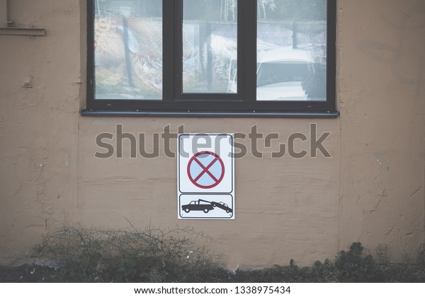 No\
parking sign hanging on the wall.\
Car evacuation\
sign