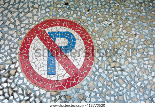 No parking\
sign made from many tile on the floor\
