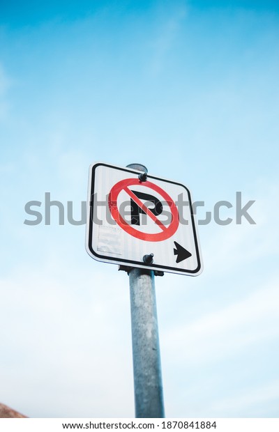 no parking sign on a\
bright sunny day