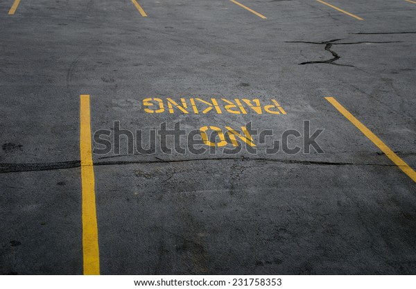 No parking sign on the\
parking lot.