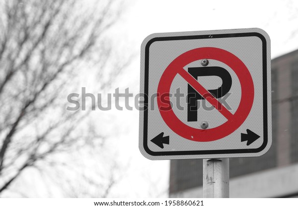 No parking\
sign on roadside - Red on\
monchrome