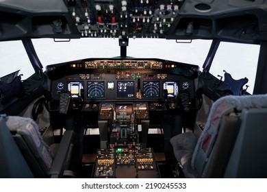 No People In Airplane Cockpit Used By Captain And Copilot To Fly, International Airways Jet With Control Panel Buttons, Steering Wheel And Dashboard Command. Flying Plane With Engine Throttle.