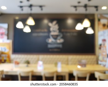 No People Blur Coffee Cup Art Of Black Board And Chair Decor Warm Light At The Coffee Shop Interior Abstract Background.