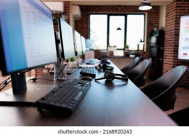 No People At Customer Service Reception With Call Center Equipment On Helpdesk. Empty Office Desk With Multiple Monitors To Give Telemarketing Assistance And Support To Clients On Hotline.