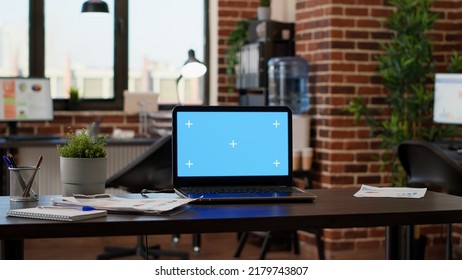 No People In Empty Startup Office With Greenscreen On Laptop, Chroma Key Background Application On Display. Computer With Isolated Mockup Template And Blank Copyspace Screen On Desk.