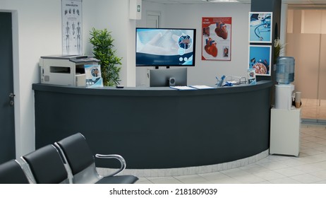 No People In Empty Waiting Area At Clinical Center With Reception Desk, Waiting Room With Seats To Start Checkup Visit Appointment. Medical Examination With Doctor At Hospital Lobby.