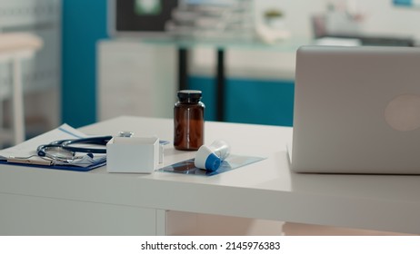 No People In Examination Cabinet With X Ray Scan And Bottle Of Pills On Desk, Medical Space Prepared For Checkup Appointment. Empty Office With Equipment And Intruments. Close Up.