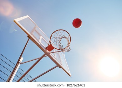 No People Photo Of A Ball Flying Into A Basketball Hoop On The Background Of Blue Skies