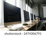 No people shot of modern computer monitors with codes on screens in classroom, copy space