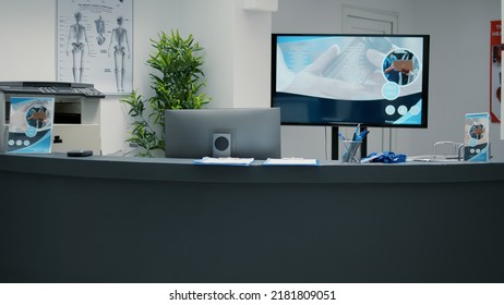 No People In Waiting Area With Reception Counter Desk At Medical Clinic, Helping Patients And Giving Support At Consultation Appointment. Waiting Room Lobby To Attend Annual Checkup Visit.