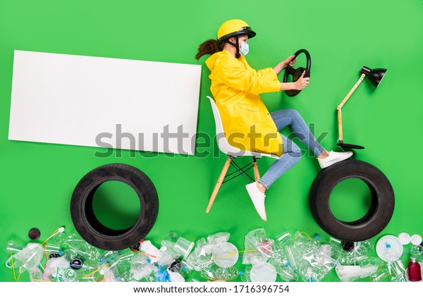 No
pollution. Full size high angle flat lay photo responsible citizen
lady drive motor bike trash recycling center plastic products
littered street nature isolated green color
background