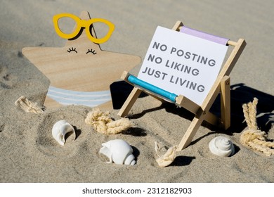 NO POSTING NO LIKING JUST LIVING text on paper greeting card on background of beach chair lounge starfish summer vacation decor. Concept of social media technology detox Sandy beach sun. Holiday - Shutterstock ID 2312182903