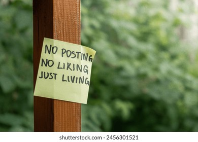 NO POSTING NO LIKING JUST LIVING text on paper note on background of greenery garden. Concept of social media technology detox. Farmcore nature core sustainable - Powered by Shutterstock