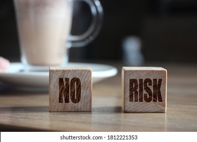 No Risk Words On Wooden Blocks And Cacao Cup. Risk Management Concept.