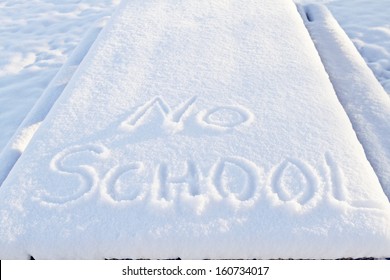 No School carefully printed in fresh snow indicates winter weather has closed local schools.  - Shutterstock ID 160734017