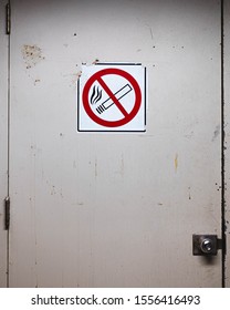 No smoking sign on a door - Shutterstock ID 1556416493