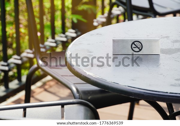 \
No\
smoking symbol placed on the black round\
table