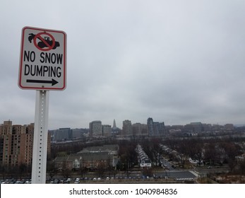 No Snow Dumping Sign With Black Arrow And Alexandria, Virginia In The Background