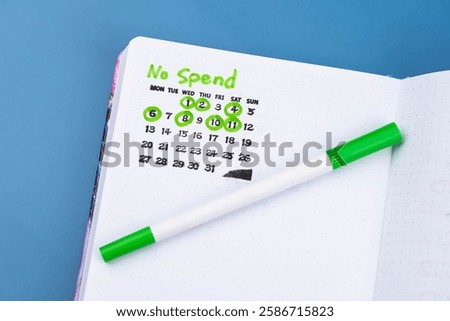 No Spend Challenge planner tracker, with checkmarks calendar marking successful no-spend days. Concept of personal finance, budgeting, financial discipline, frugality, and mindful spending habits