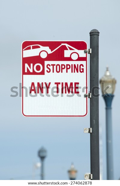 No Stopping Any Time Sign with image of car being\
towed away.