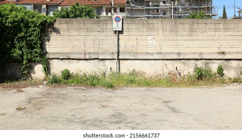 No stopping sign on a grunge concrete wall in a desolate urban road, Background for copy space.