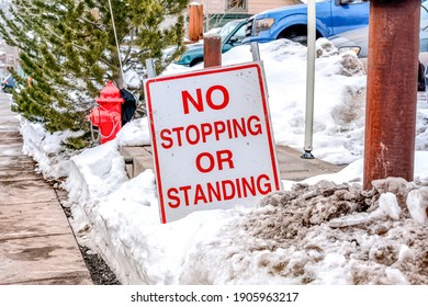 No Stopping Or Standing Signage On A Snowy Road Side Along A Pathway In Winter