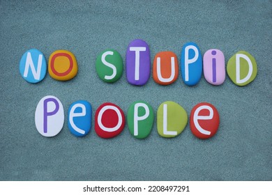 No Stupid People, Creative Slogan Composed With Multi Colored Stone Letters Over Green Sand