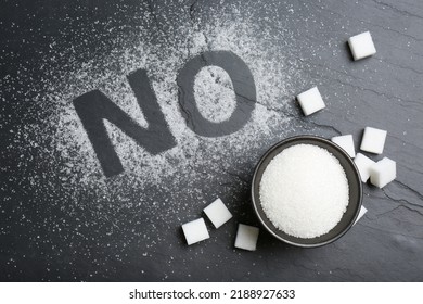 No Sugar. Flat Lay Composition With Refined Cubes And Granules On Black Table