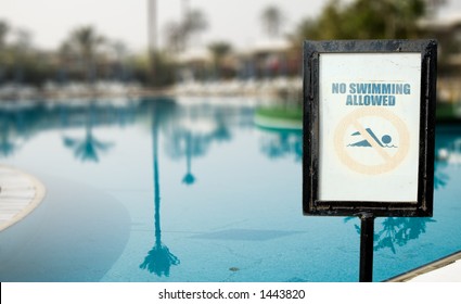 No Swimmin Allowed over swimming pool background.
