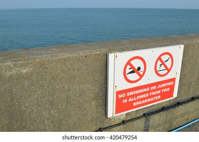 No swimming or jumping from breakwater sign.