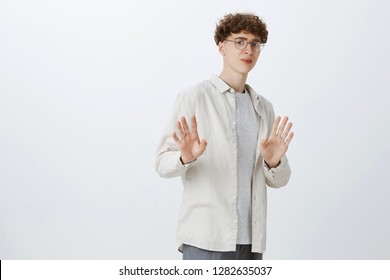 No Thanks I Refuse And Decline. Intense Displeased Handsome Guy With Round Glasses And Shirt Raising Hands In Rejection, Disagree As Invitation Seem Suspicious Posing Dissatisfied Over Gray Wall