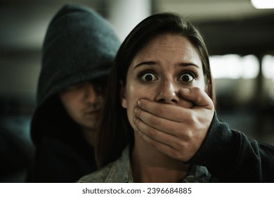 No, this cant be happening. A terrified young woman held captive by a man with his hand over her mouth.