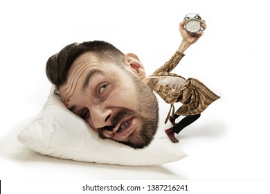 No Time For Breakfest Again. Big Head On Small Body Lying On The Pillow. Man In Home Suit Holding Alarm Cannot Wake Up 'cause Headache And Overslept. Concept Of Business, Working, Time Limits.