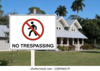 A No trespassing sign in front of an upscale house. Concept of privacy, warning trespassers.