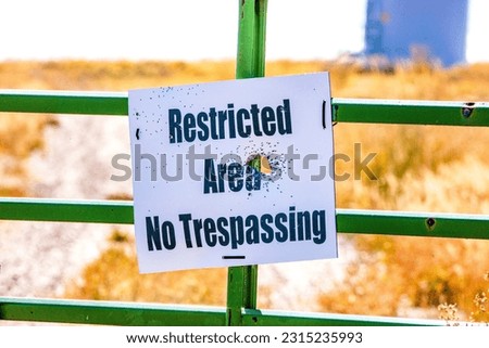 No Trespassing sign with gunshot